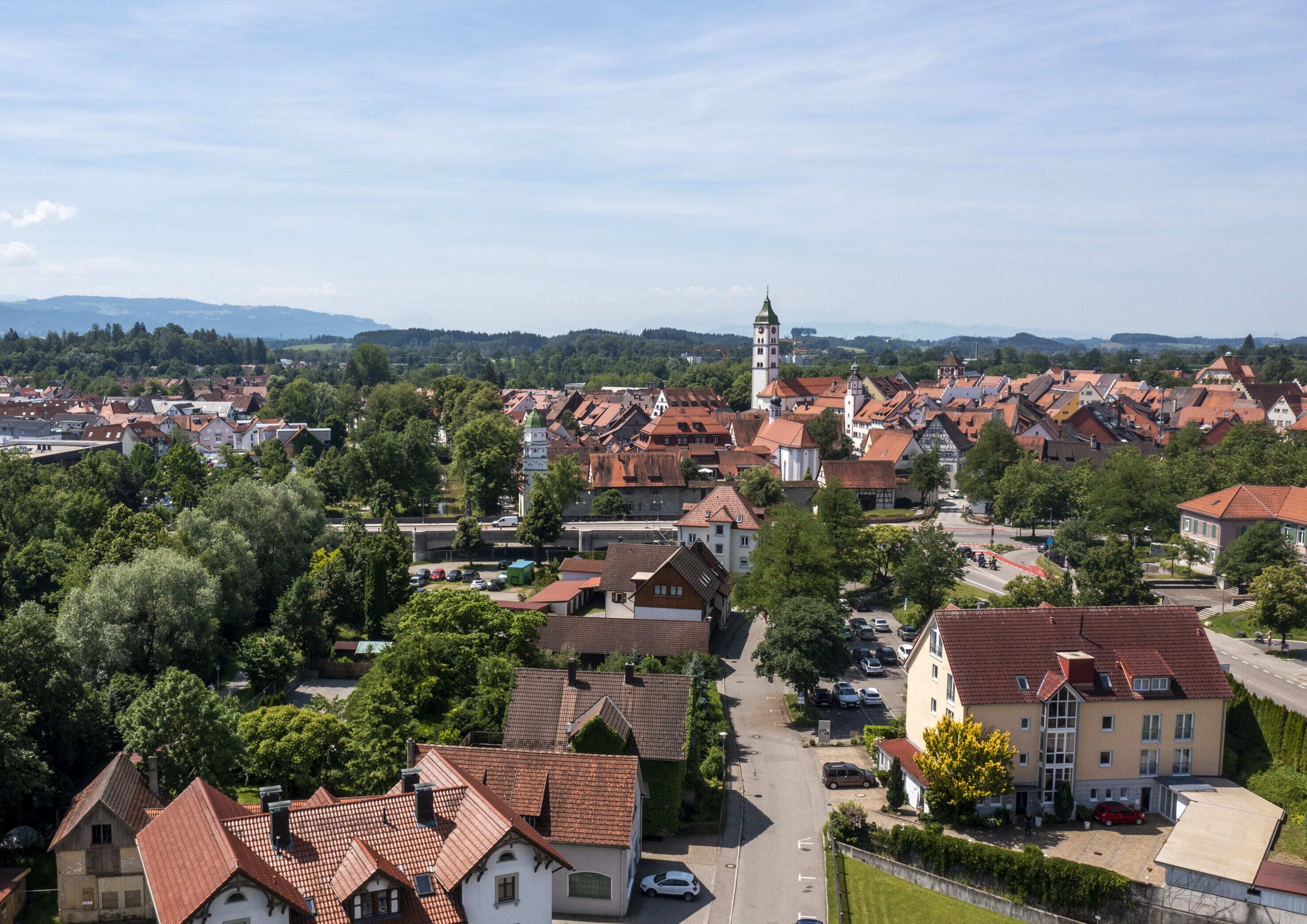 A town with traditional architecture, including a prominent tower and a mix of residential and commercial buildings.