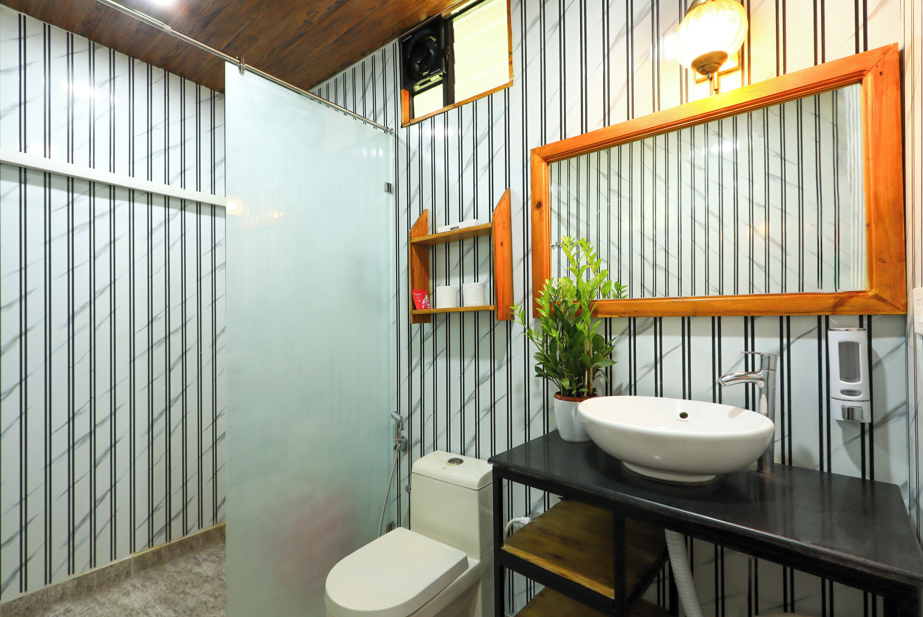 A bathroom with a toilet, sink, and shower.