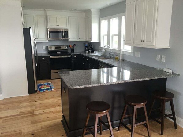 Fridge, microwave, oven, stovetop - Discover 'Best Day Ever': 4BR, 3BA beach house on Holden Beach, perfect for family fun! (Holden Beach)