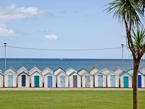 A row of beach huts with a view of the sea. - Comfort and luxury in a sea front location with panoramic sea views. (Paignton)