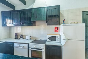 A kitchen with a dishwasher, stove, oven, microwave, and refrigerator.