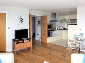 A modern apartment with a living room, kitchen, and dining area. - A breathtaking apartment in a unique position. (Westward Ho!)