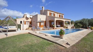 A two-story house with a swimming pool, outdoor seating, and a pergola. - Finca with sea views and pool special offer last week of August (Calonge)