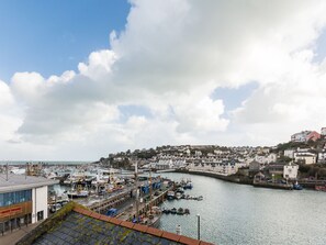 A harbor with boats docked, a building labeled "Gway House," and a town with houses on a hillside. - 2 bedroom accommodation in Brixham (Brixham)