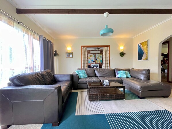 A living room with a sofa set, a coffee table, and a hanging light fixture. - Sunryes Beach House @the Heart of Rye Beach & Shops: Longer Stay Welcome (Rye)