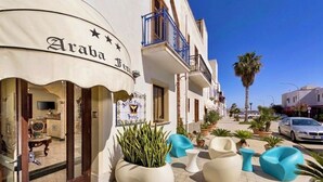A hotel named 'Araba Hotel' with outdoor seating and potted plants. - Araba Fenice (San Vito Lo Capo)