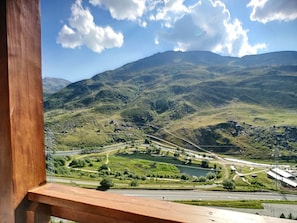 Enjoy breathtaking views of the surrounding mountains and serene lake from this scenic balcony.