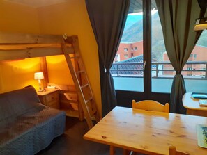 Enjoy a compact room with a single bed, bedside table, and window offering a view of the surrounding landscape.