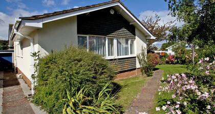 A family friendly retreat with large garden, close to a secluded cove.