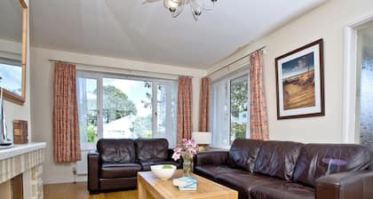 A family friendly retreat with large garden, close to a secluded cove.