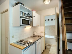 Enjoy cooking in this compact kitchen with microwave, stovetop, and dishwasher.
