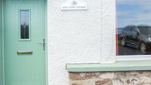 A teal door with a small window, a white textured wall, and a sign reading "SEAL VIEW COTTAGE". - 2 bedroom accommodation in Burnmouth, near Eyemouth (Burnmouth, near Eyemouth)