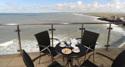 Panoramic views over the beach from a stylish apartment in a landmark building.