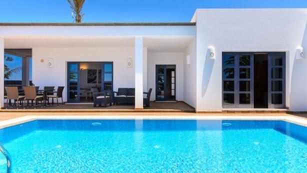 A modern building with a swimming pool, outdoor seating, and large windows. - Luxury villas Mamma Mía Villa A Parking & pool private (Playa Blanca)