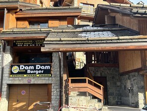 A building with a sign for 'Dam Dam Burger' and a 'Take Away' service.