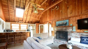 Ein rustikales Ferienhaus-Interieur mit Küche, Essbereich und Wohnzimmer.