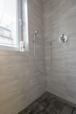 Apartment 8 | Bathroom | Rainfall showerhead, free toiletries, hair dryer, slippers