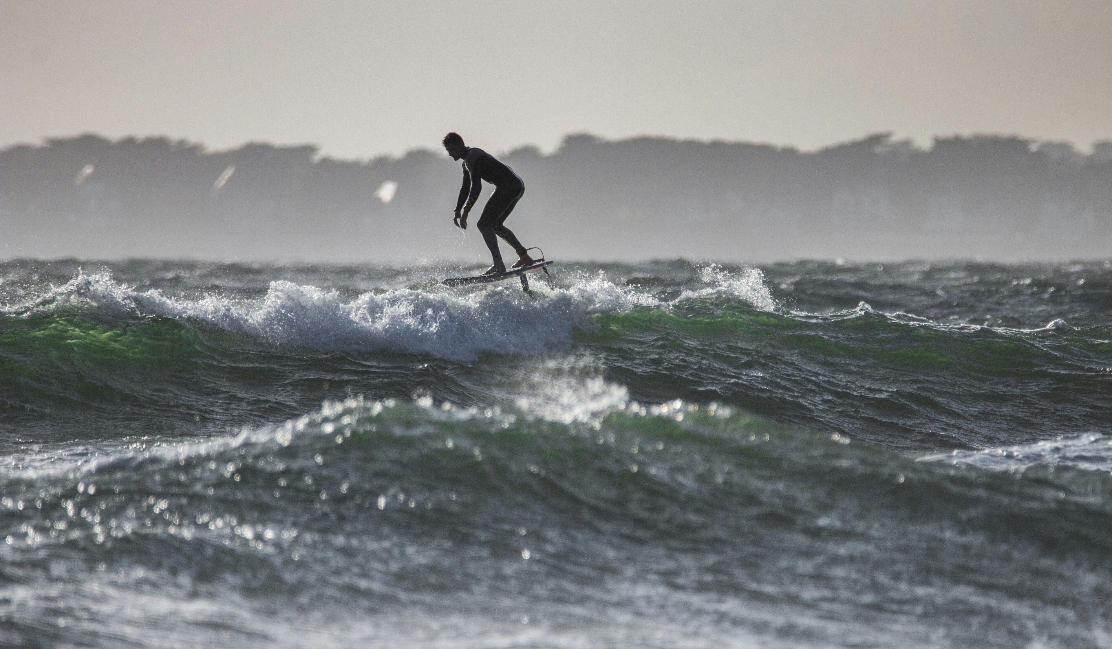 A surfer riding a wave in the ocean.
