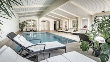 Indoor pool, pool umbrellas, pool loungers