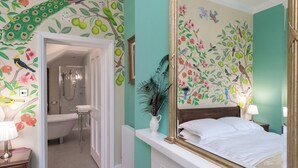 A bedroom with a large mirror, a bed, and a bathroom with a shower and toilet. - 1 bedroom accommodation in Wirksworth, near Matlock (Wirksworth, near Matlock)
