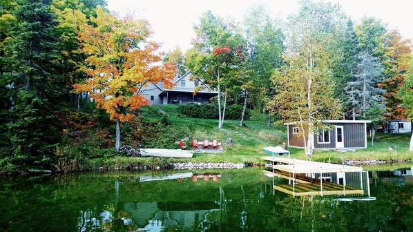 Escape to a serene lakeside retreat with a dock and lush surroundings.