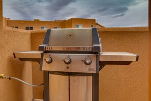 Outdoor grill with three burners and a side burner, perfect for cooking up a meal.