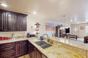 Enjoy meals in the well-lit kitchen with a large sink and dining area.