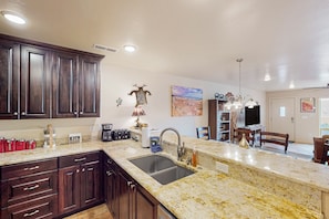 Enjoy meals in the well-lit kitchen with a large sink and dining area.