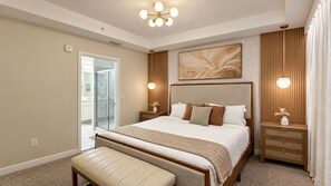 A bedroom with a large bed, bedside tables, a bench, a ceiling light fixture, and a wall-mounted artwork. - Sophisticated Holiday Condo, Only 7 min to Disney (Kissimmee)