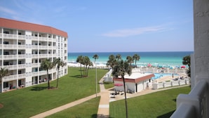 A hotel with multiple balconies overlooking a beach, a pool area, and a clear view of the ocean. - El Matador 440 -  FREE TICKETS!! Your stay includes free tickets to many area attractions! (Fort Walton Beach)
