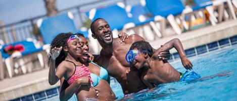 A swimming pool with people enjoying the water.