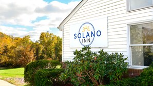 A white building with a sign that reads "Solano Inn".