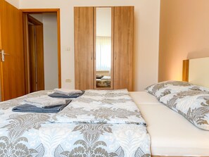 Une chambre à coucher avec un lit, une armoire et un miroir.