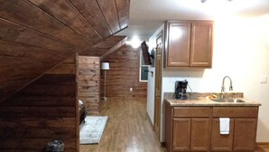 A kitchen with wooden cabinets, a countertop, and a sink. - Marvelous! Professionally Cleaned, Self Check In - Sleeps 14 (Racine)