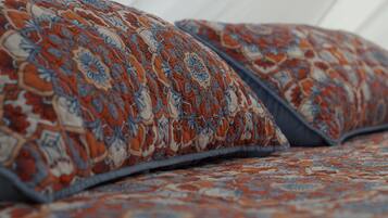 A patterned bedspread with a floral design.
