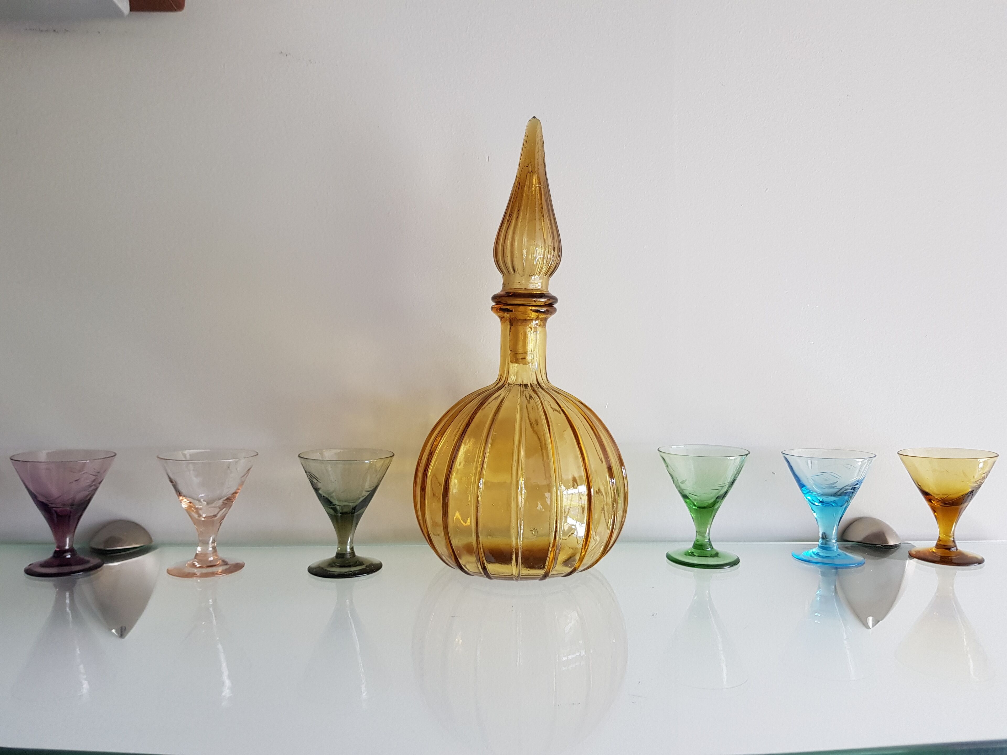 A collection of glassware on a reflective surface.