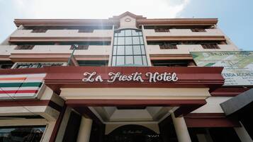 The entrance to La Fiesta Hotel with a clear view of the hotel's name.
