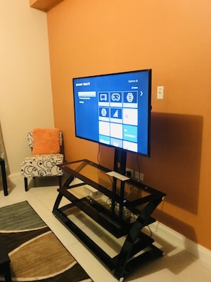 A television mounted on a wall with a screen displaying a user interface.