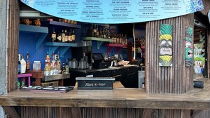 Eine Barbereich mit einer Speisekarte, auf der verschiedene Getränke und Cocktails aufgeführt sind.