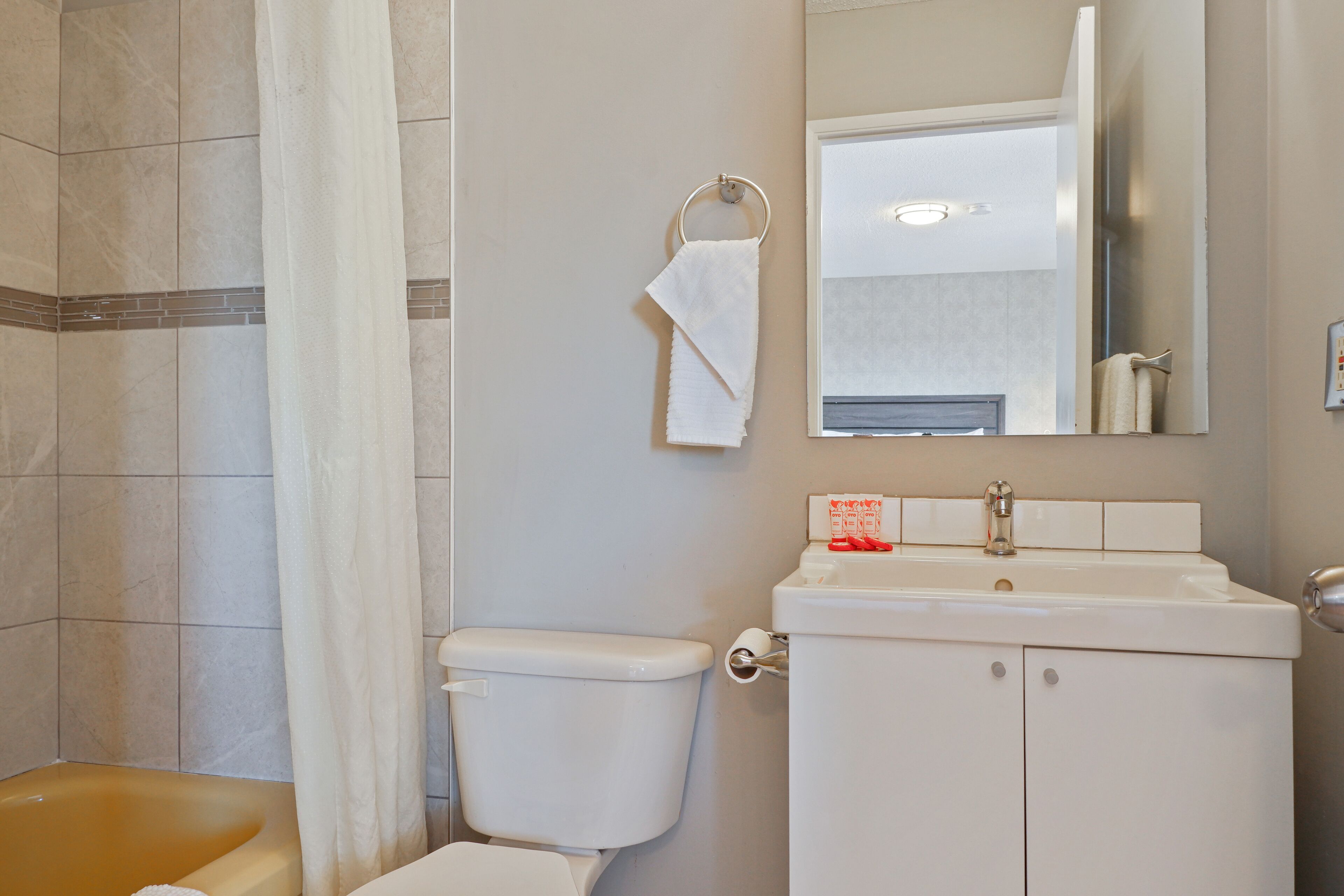A bathroom with a toilet, sink, and shower area.
