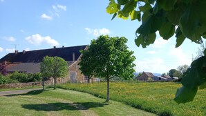 A rural landscape with a gravel path, green grass, and a tree in the foreground. - "Les Vieux Poiriers" (near Taize, Cluny ..) in Bonnay 71460 (Cluniac site) (Bonnay)