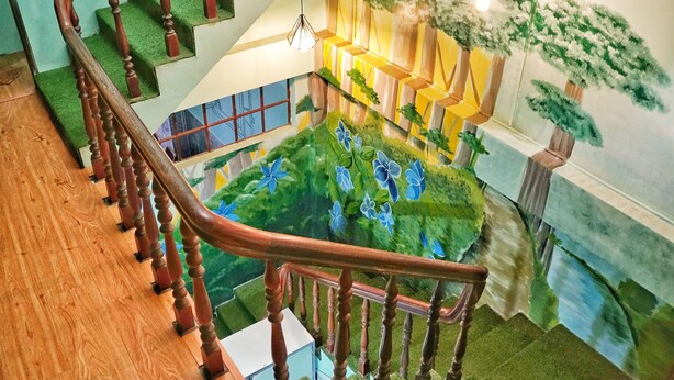 A wooden staircase with a railing leading to a lower level. - Sunny Hostel (Can Tho)