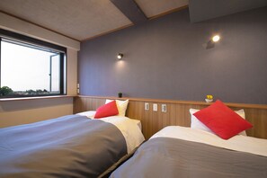 A hotel room with two beds, a window, and a view of the city. - Narita AIC Airport Hotel (Narita)