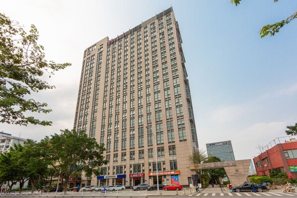 A tall, modern building with multiple floors and a prominent entrance.