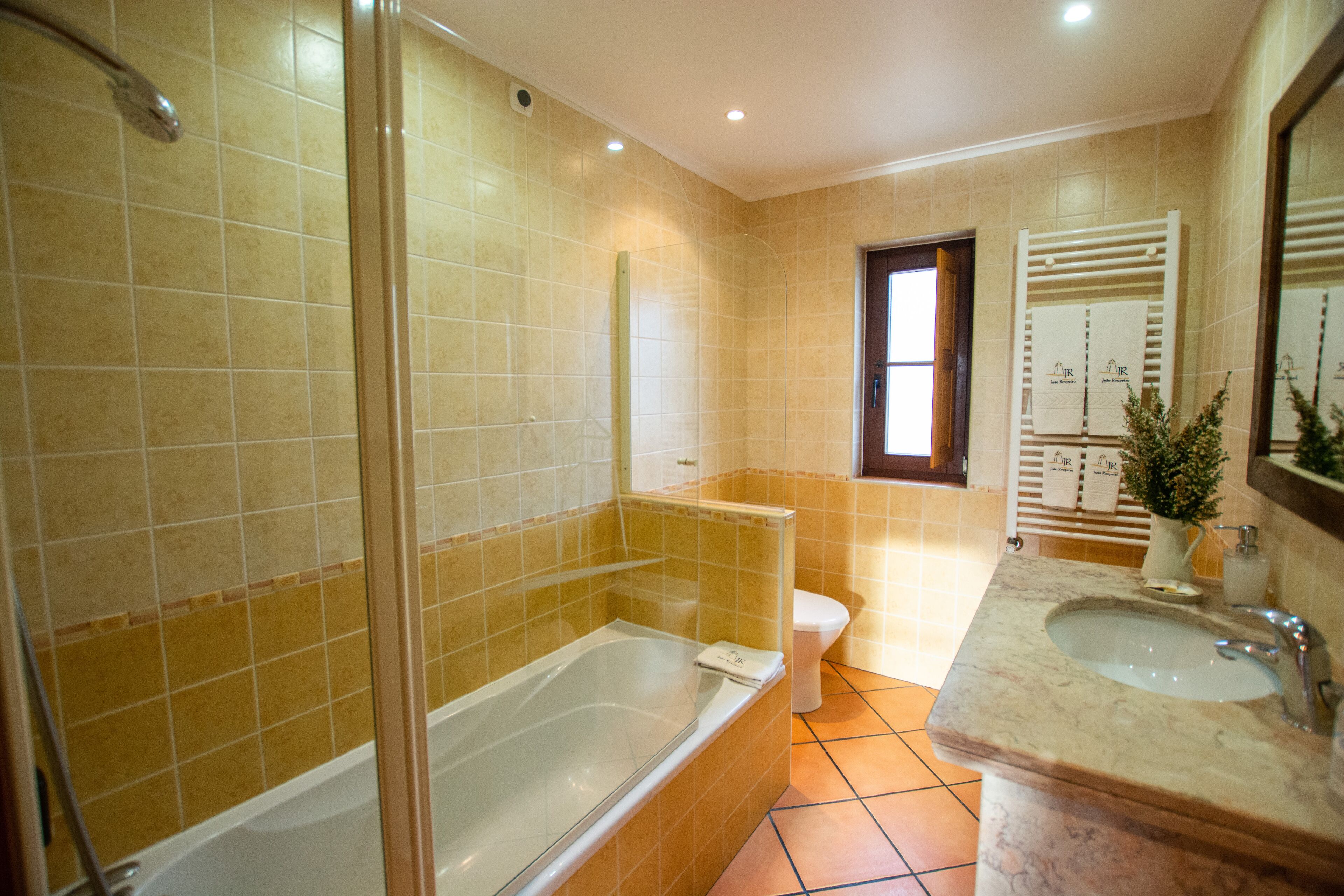 A bathroom with a bathtub, toilet, and sink.