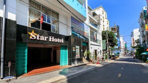 A Star Hotel with a modern facade, a visible entrance, and a clear street view. - Star Hotel (Ho Chi Minh City)
