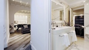 A modern bathroom with a large mirror, a double sink, and a dark headboard. - Reale Luxury home  (Roma)
