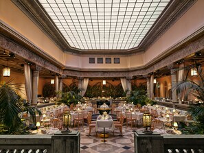 A spacious, elegantly decorated banquet hall with high ceilings and a grid-patterned skylight. - Britannia Hotel (Trondheim)