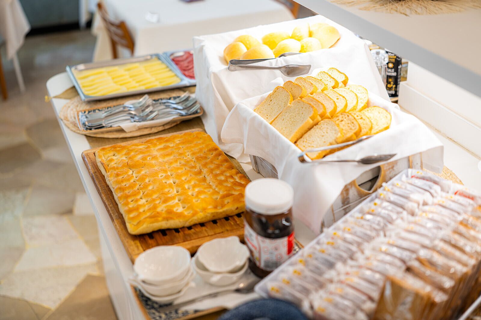 A buffet with various food items and utensils.