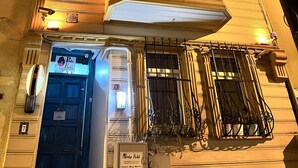 A hotel with a prominent entrance, a balcony with a railing, and a security camera. - Pembe Hotel (Istanbul)